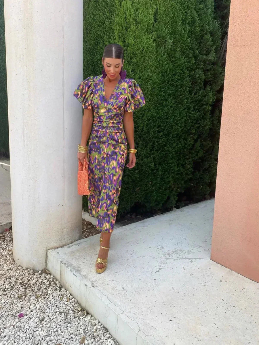 Women’s purple-blue printed midi dress with V-neck and puff sleeves, fitted waist.