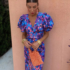 Women’s printed midi dress with puff sleeves and V-neck in blue and purple, waist tie.