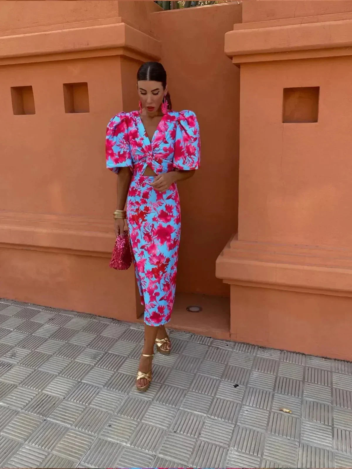 Women’s printed midi dress with puff sleeves and V-neck in pink and blue floral pattern.