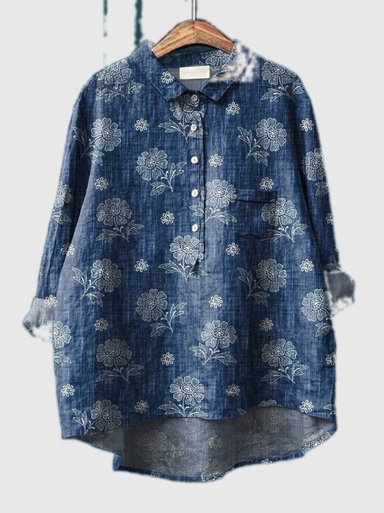 Embroidered denim-blue shirt with light floral vine designs, button-up front and patch pocket