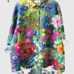 Embroidered floral shirt with blue, green, pink, and yellow scattered blooms, button-up front