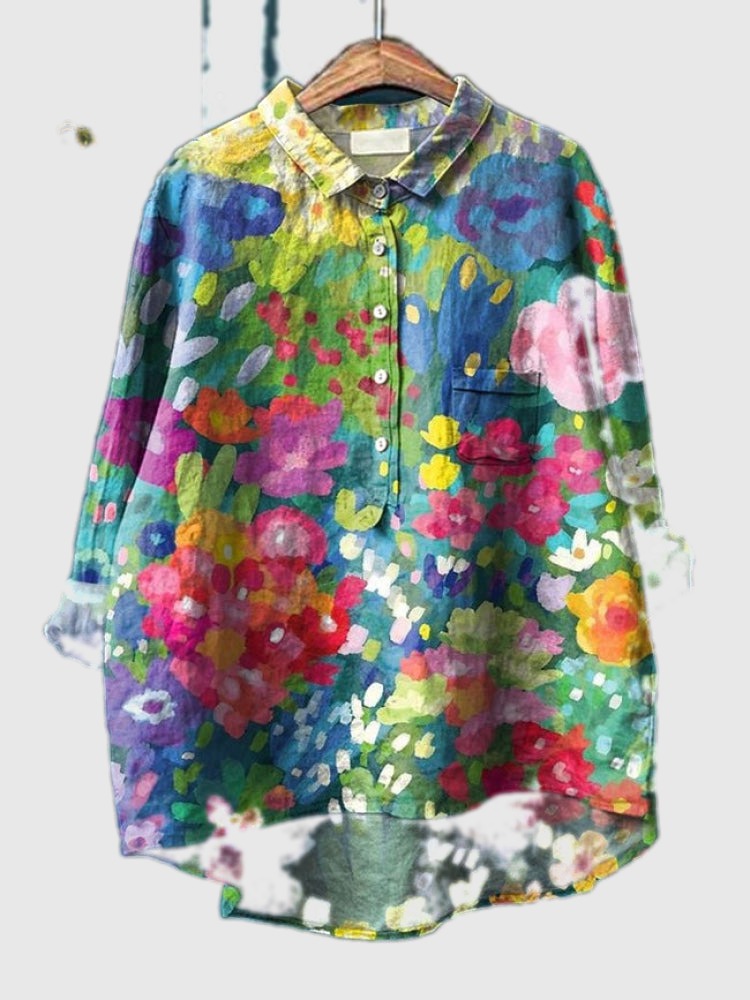 Embroidered floral shirt with blue, green, pink, and yellow scattered blooms, button-up front
