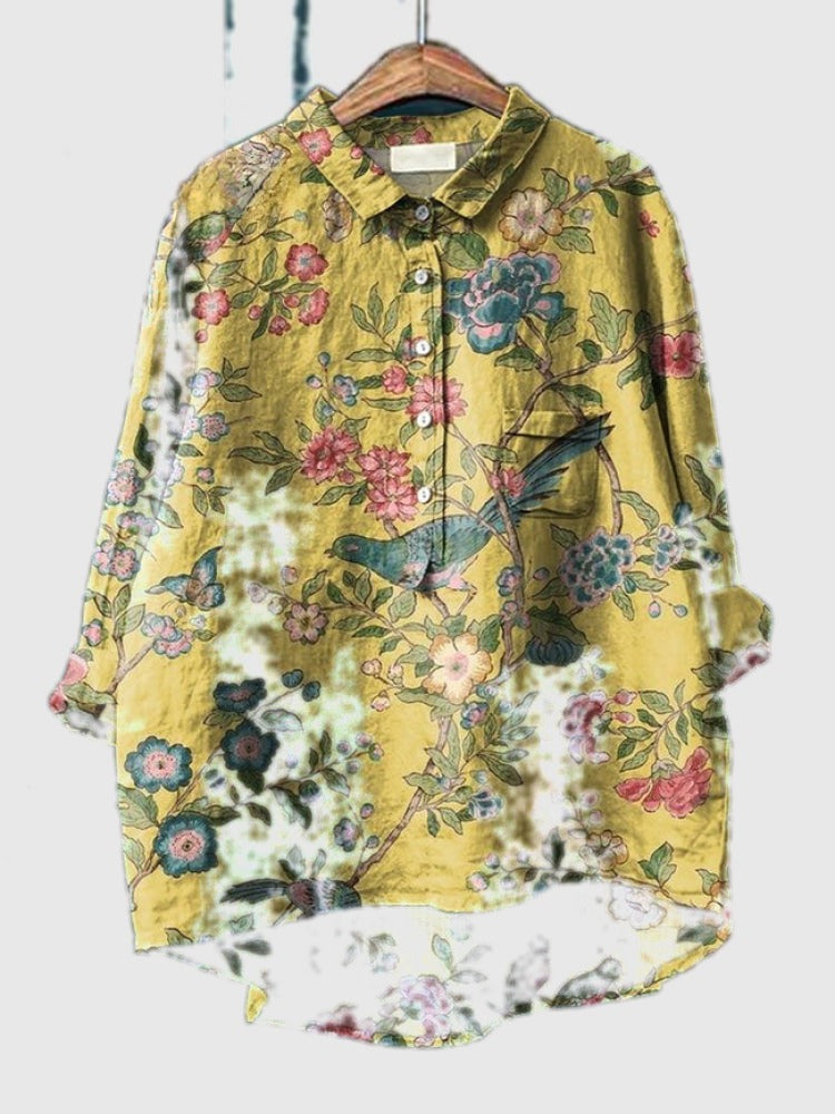 Embroidered floral shirt in yellow with pink and blue blossoms, button-up front and pocket