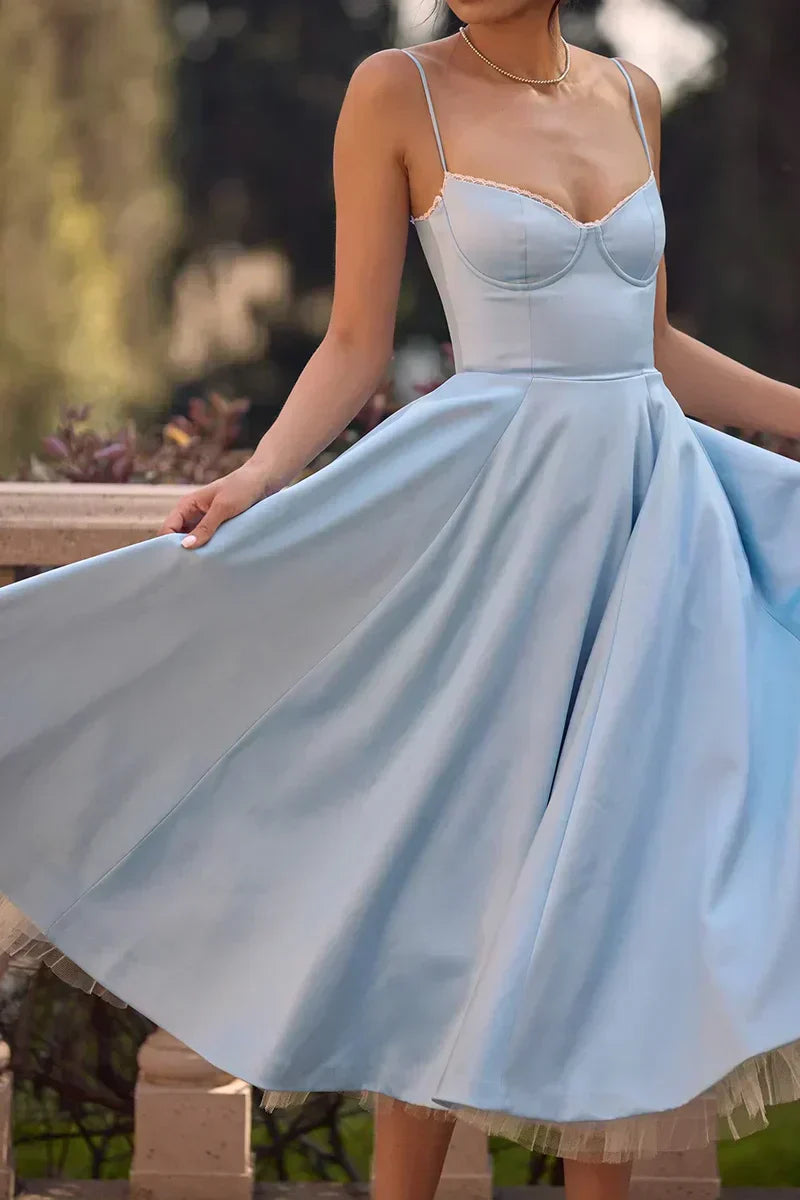 Light blue fit-and-flare dress with spaghetti straps and sweetheart bodice, flared tulle skirt.