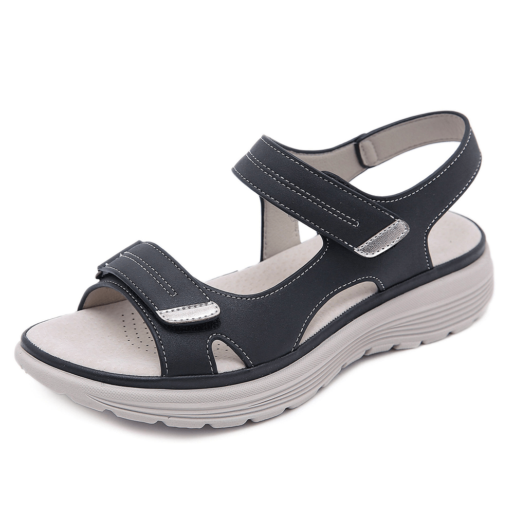 Black orthopedic sandals with cross straps, hook-and-loop closure, and platform sole