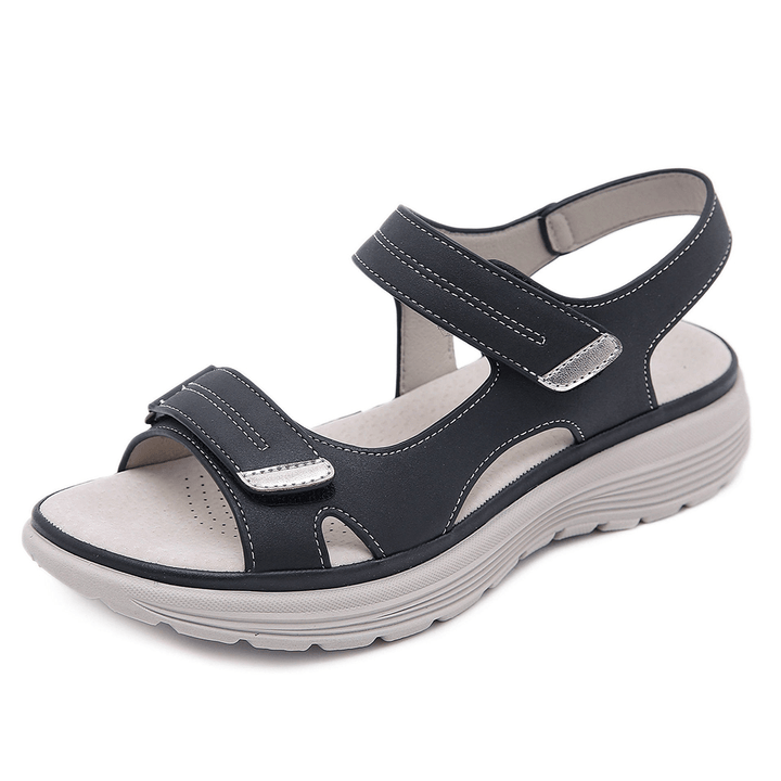 Black orthopedic sandals with cross straps, hook-and-loop closure, and platform sole