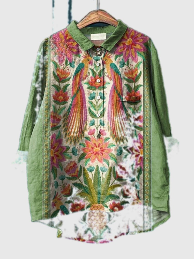 Green button-up tropical shirt with collar, long sleeves, and multicolor peacock print