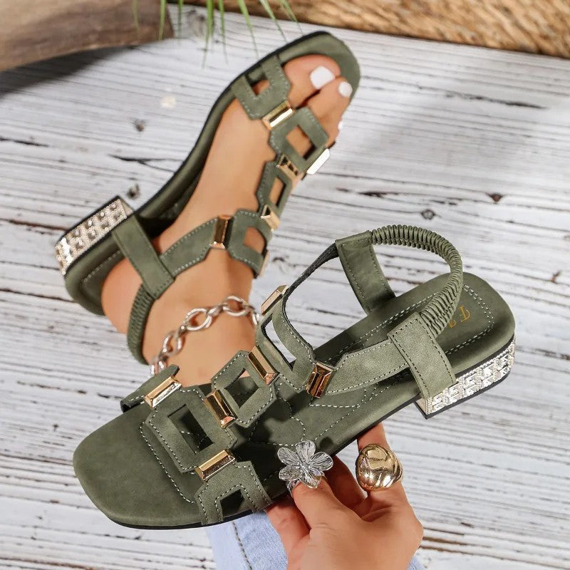 Green crystal heel sandals with open toe, geometric rhinestone straps, and block heel.