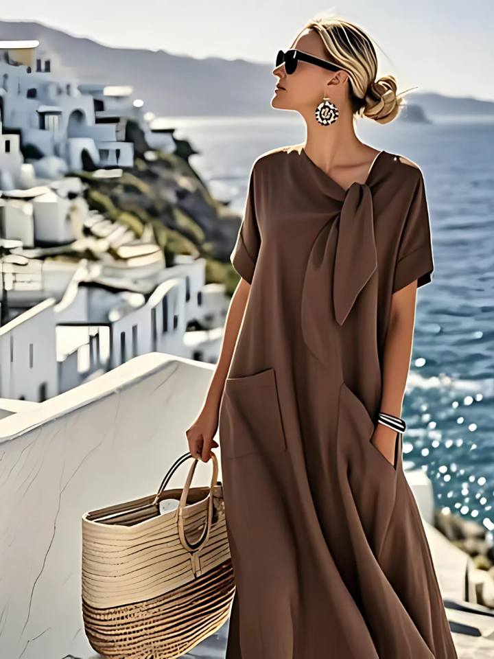 Brown midi dress with short sleeves, tied neck bow, and side pockets