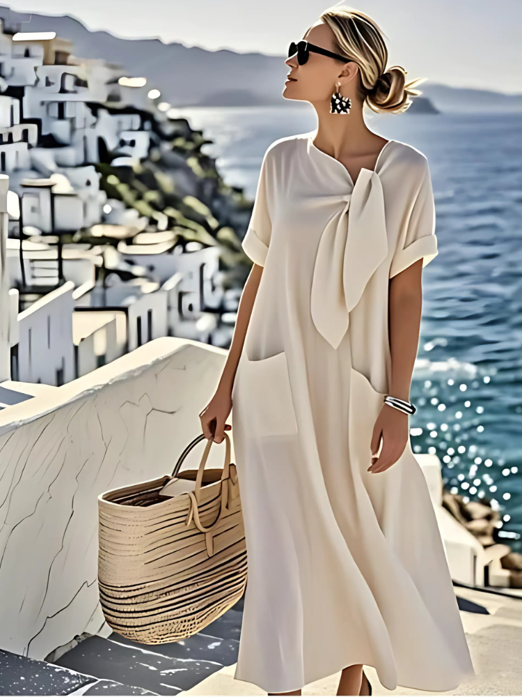 Beige midi dress with short sleeves, tied neck bow, and side pockets