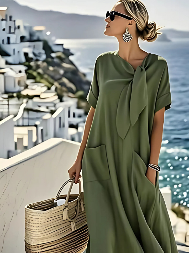 Green midi dress with short sleeves, tied neck bow, and side pockets