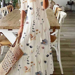 Floral maxi dress in white with long sleeves and scattered multi-color flower print