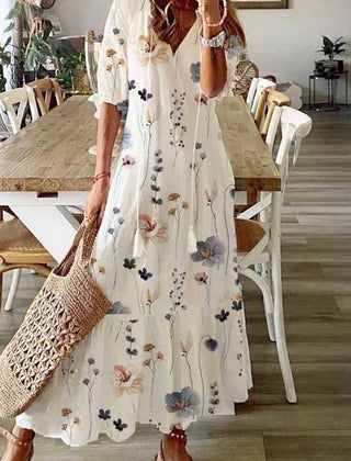 Floral maxi dress in white with long sleeves and scattered multi-color flower print