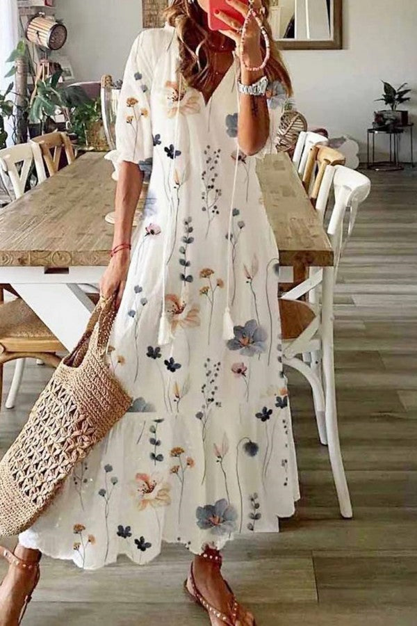 Floral maxi dress in white with long sleeves and scattered multi-color flower print