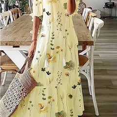 Floral maxi dress in pale yellow with long sleeves and scattered flower print