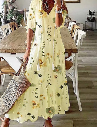 Floral maxi dress in pale yellow with long sleeves and scattered flower print