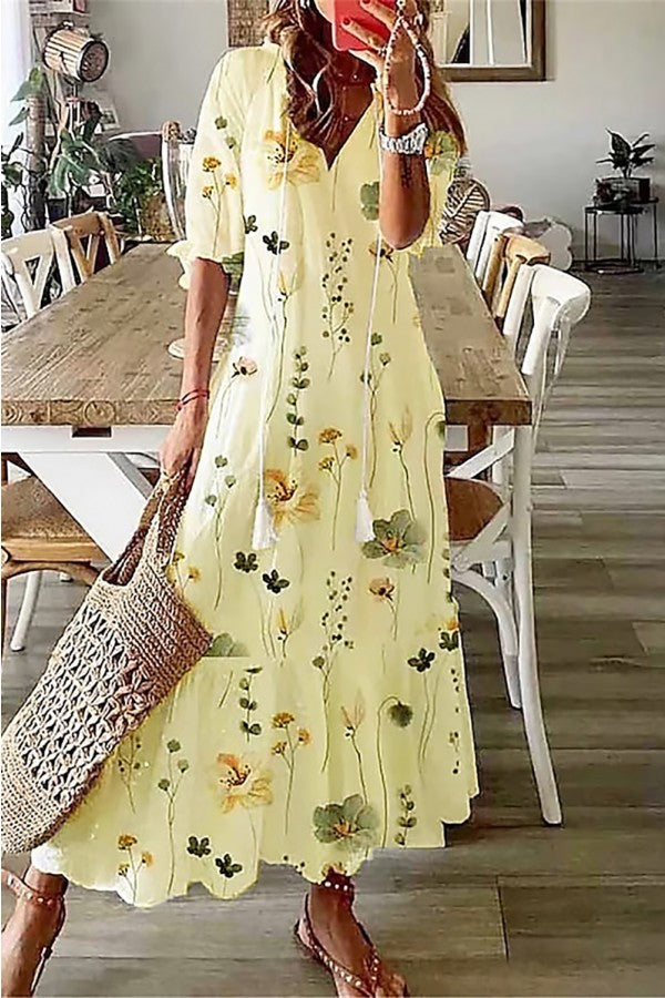 Floral maxi dress in pale yellow with long sleeves and scattered flower print