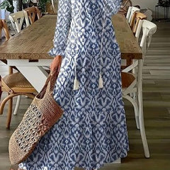 Blue ikat-style maxi dress with long sleeves, V-neck, and gathered skirt