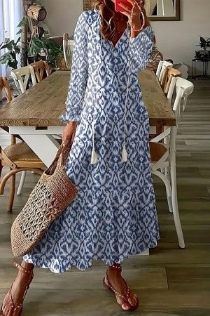 Blue ikat-style maxi dress with long sleeves, V-neck, and gathered skirt