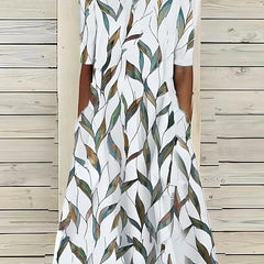 White midi dress with green and beige leaf pattern, short sleeves, round neck
