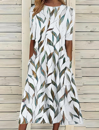 White midi dress with green and beige leaf pattern, short sleeves, round neck