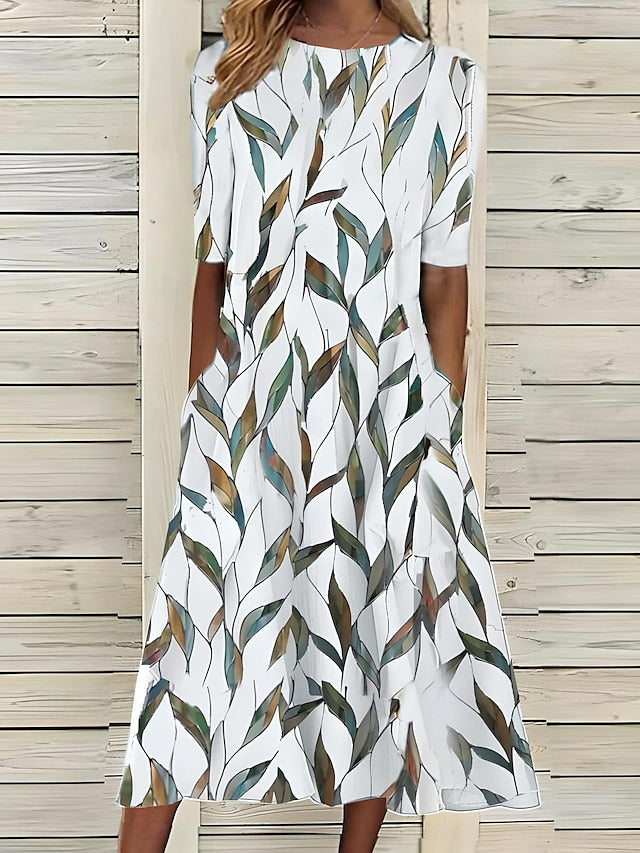 White midi dress with green and beige leaf pattern, short sleeves, round neck