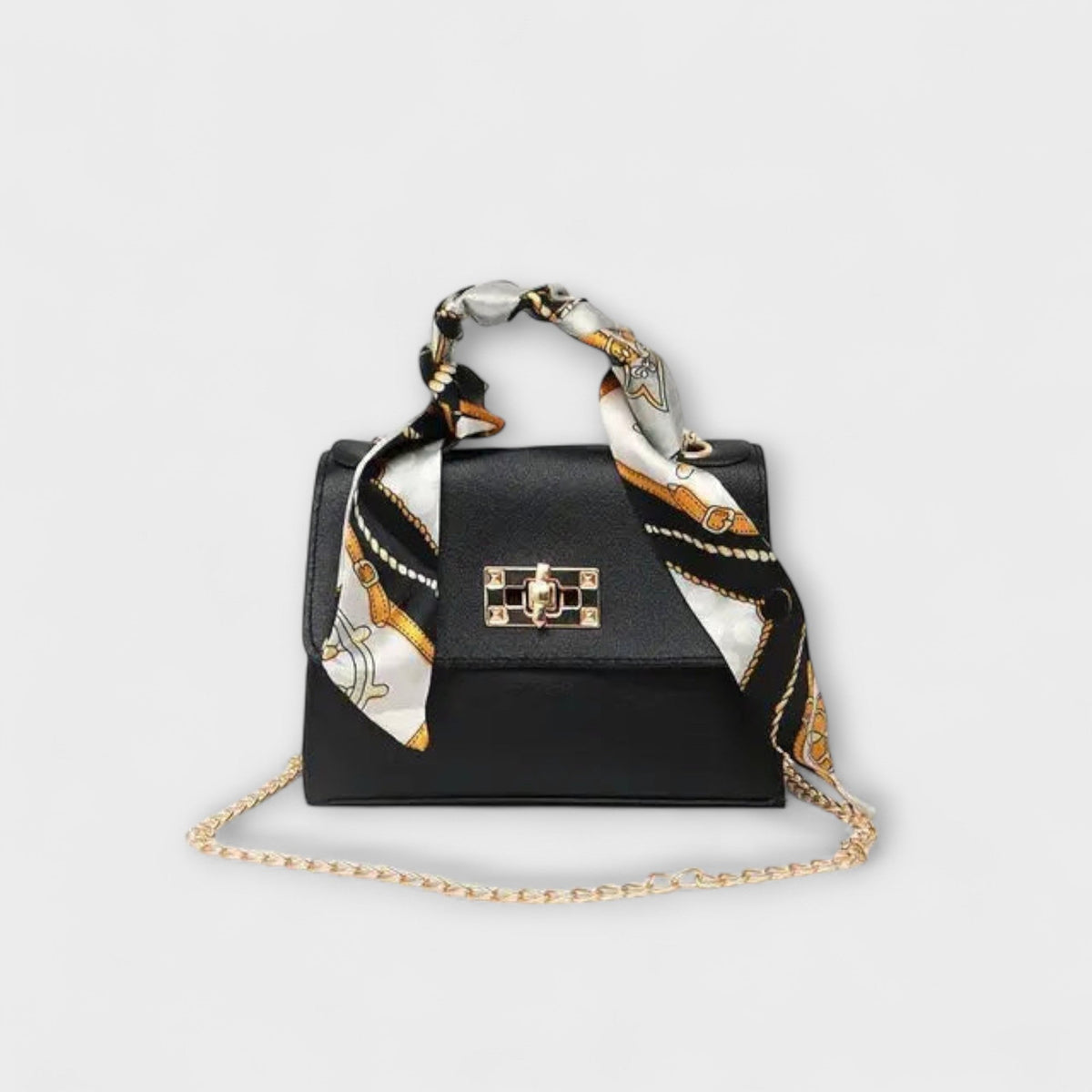 Black handbag with gold clasp, chain strap, and patterned scarf handles