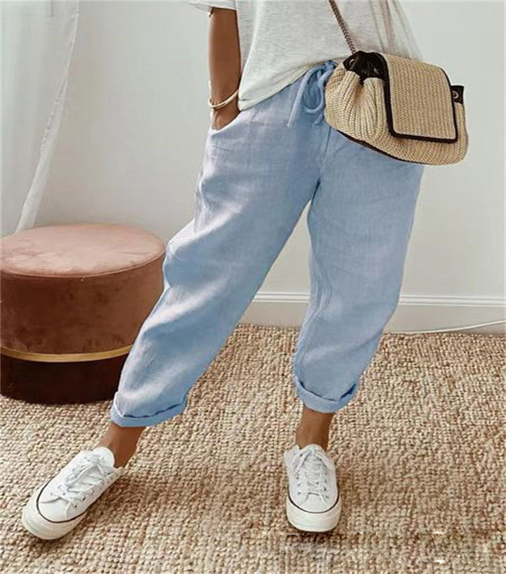 Light blue cotton trousers with elastic waist and cuffed hems