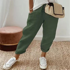 Dark green cotton trousers with elastic waist and cuffed hems