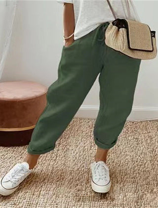 Dark green cotton trousers with elastic waist and cuffed hems