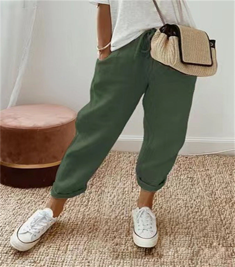 Dark green cotton trousers with elastic waist and cuffed hems