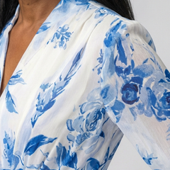 Blue floral long-sleeve wrap dress close-up on shoulder and sleeve; lightweight fabric