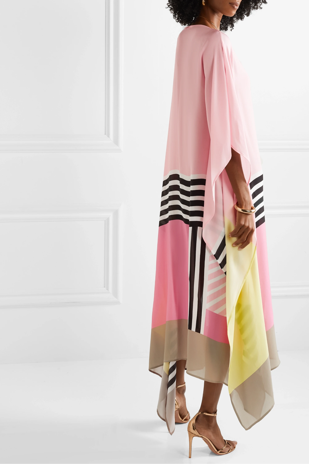 Pink geometric kaftan with color-block stripes (yellow, black) and flowing draped hem