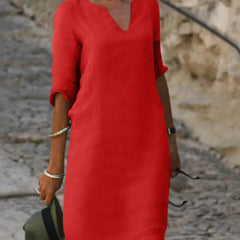 White V-neck dress with elbow-length sleeves and a straight, knee-length fit