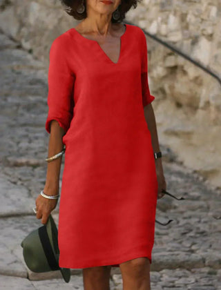 White V-neck dress with elbow-length sleeves and a straight, knee-length fit