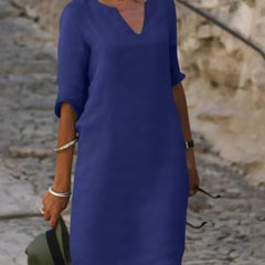 Deep blue V-neck dress with elbow-length sleeves and a straight, knee-length fit