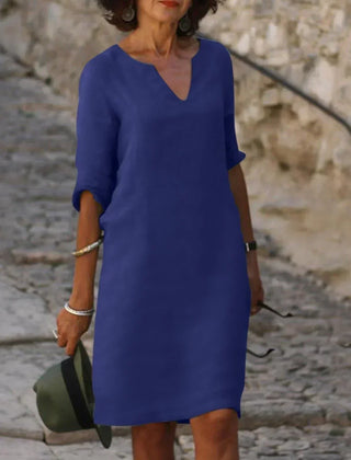Deep blue V-neck dress with elbow-length sleeves and a straight, knee-length fit