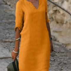 Red V-neck dress with elbow-length sleeves and a straight, knee-length fit