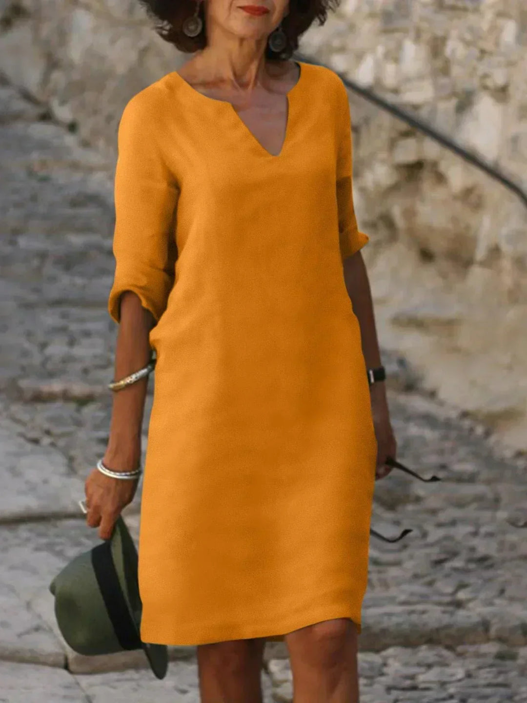 Red V-neck dress with elbow-length sleeves and a straight, knee-length fit