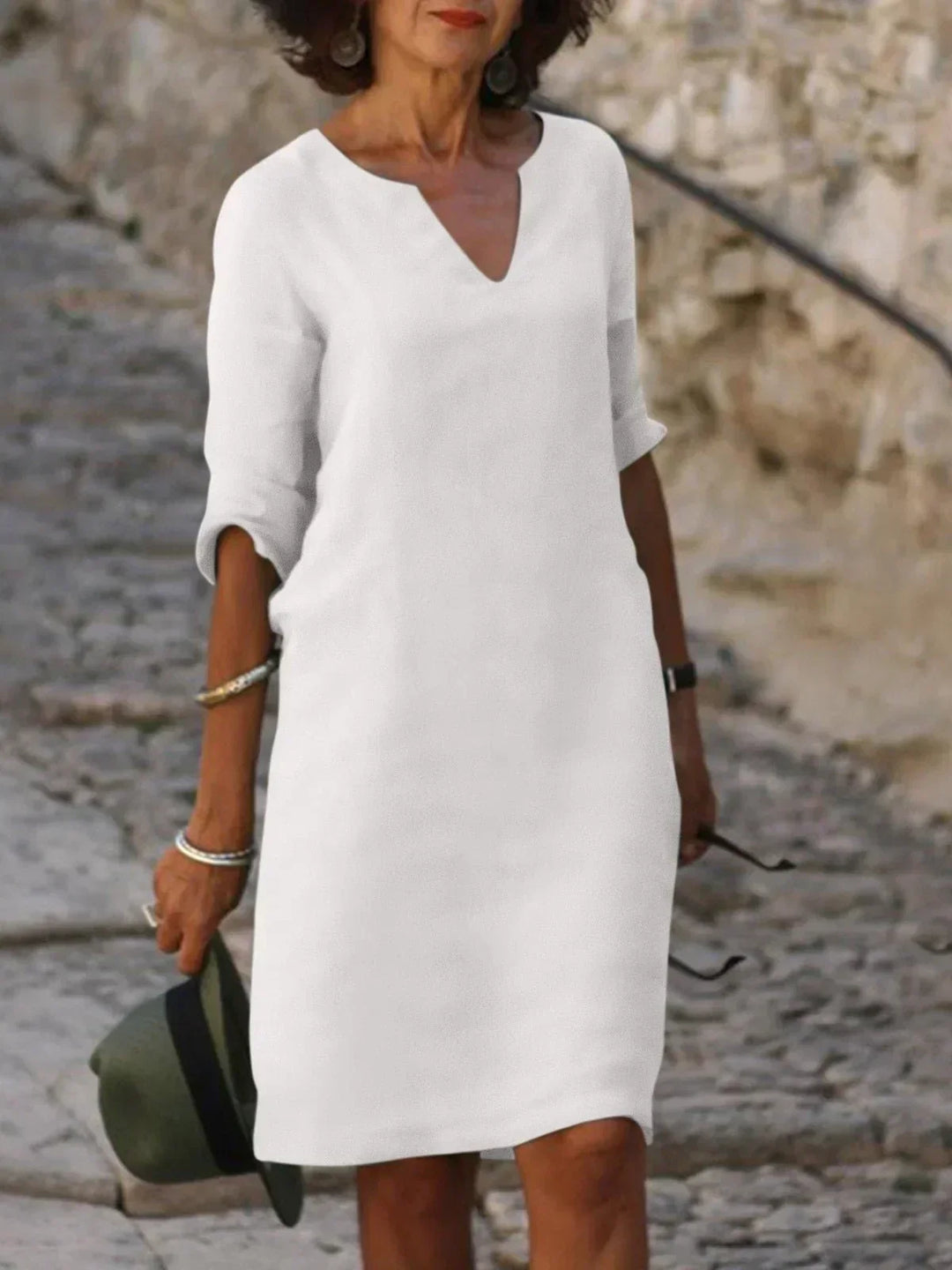 Yellow V-neck dress with elbow-length sleeves and a straight, knee-length fit