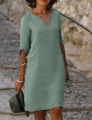 Orange V-neck dress with elbow-length sleeves and a straight, knee-length fit