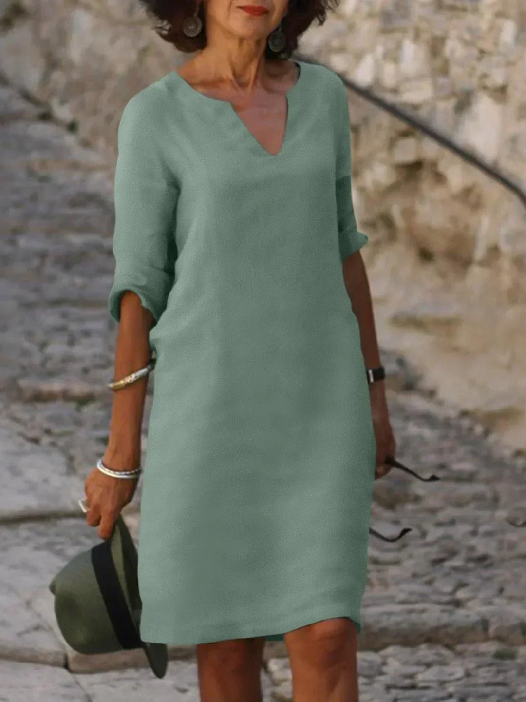 Orange V-neck dress with elbow-length sleeves and a straight, knee-length fit