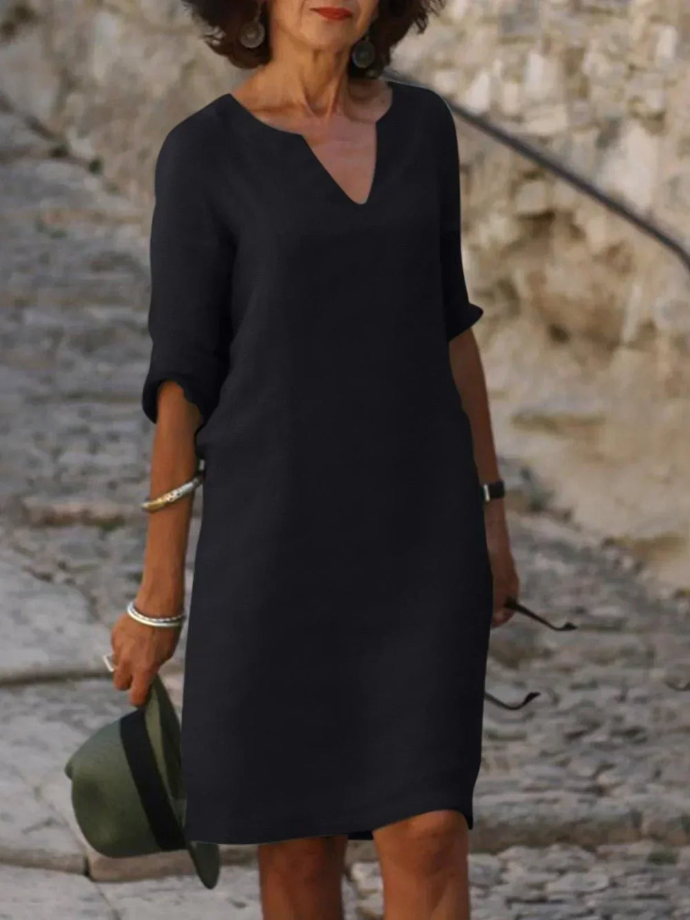 Green V-neck dress with elbow-length sleeves and a straight, knee-length fit