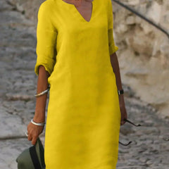 Navy blue V-neck dress with elbow-length sleeves and a straight, knee-length fit