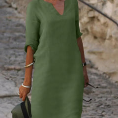 Light green V-neck dress with elbow-length sleeves and a straight, knee-length fit