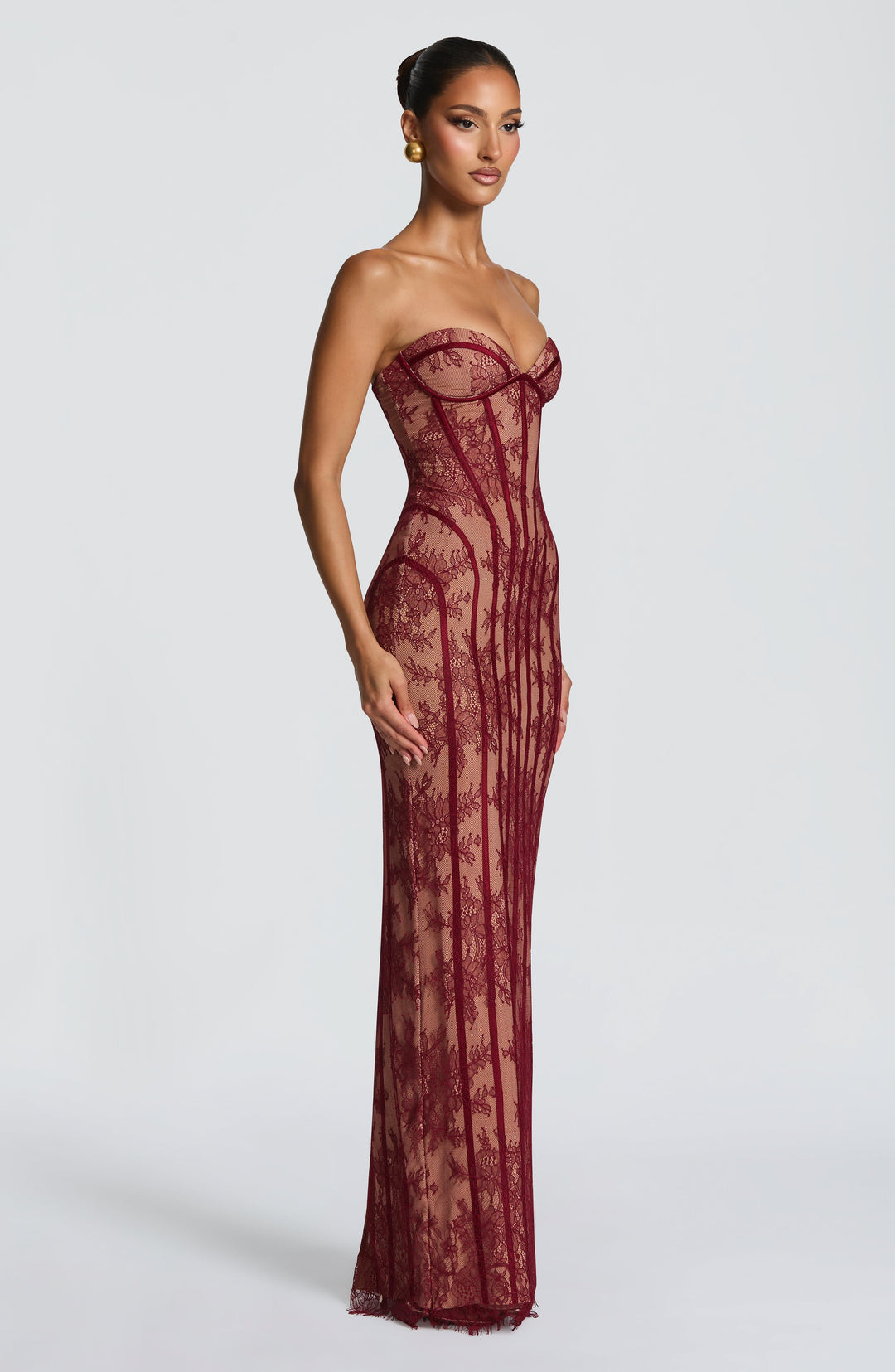 Burgundy maxi dress with straight corset neckline and vertical stripe texture, side view