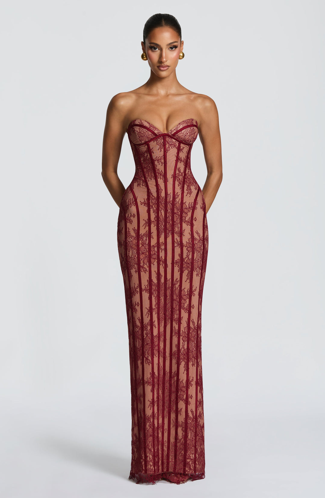 Burgundy strapless maxi dress with sweetheart corset bodice and vertical lace stripe design