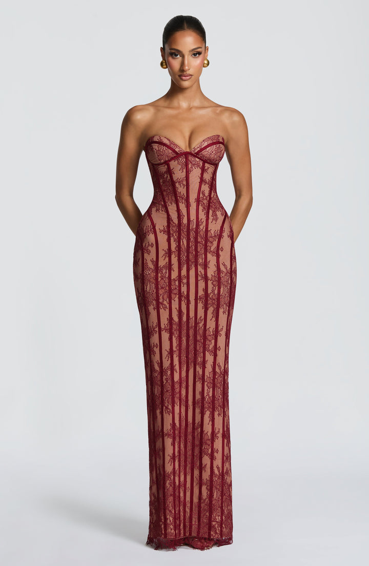 Burgundy strapless maxi dress with sweetheart corset bodice and vertical lace stripe design