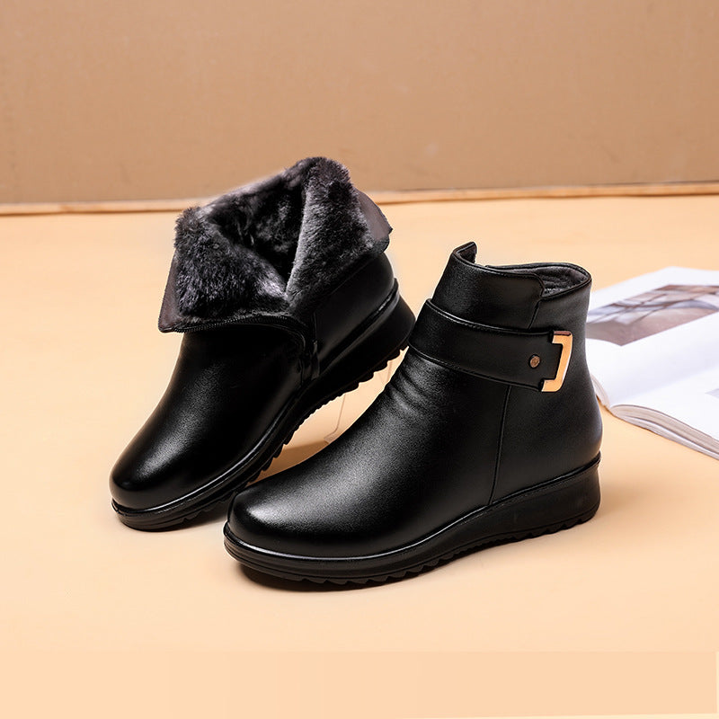 Black ankle boots with faux-fur collar, side buckle strap, and cushioned sole
