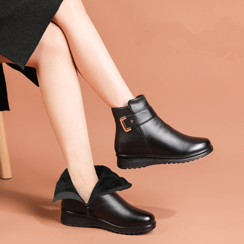 Black slip-on ankle boots with faux-fur trim and side buckle accent